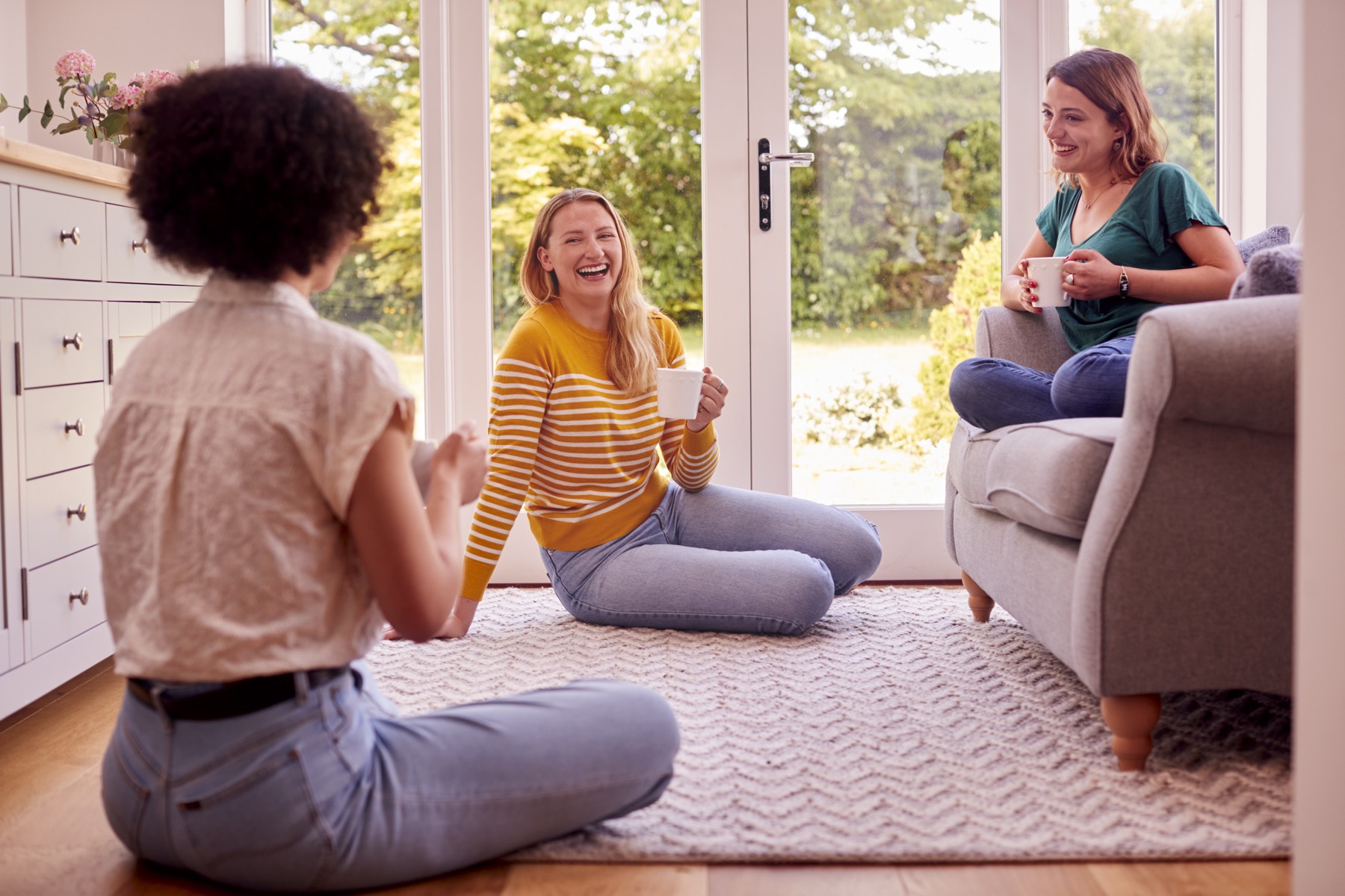Residents sharing coffee and conversation in a bright, welcoming home