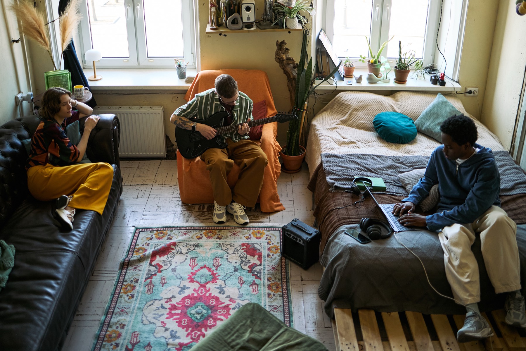 Residents relaxing and pursuing hobbies in a shared home